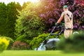 Residential Garden Worker Trimming Backyard Lawn