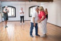 Caucasian retired couple kissing in dance studio Royalty Free Stock Photo