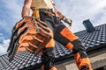 Caucasian Roofing Contractor Worker Moving a Black Roof Ceramic Tiles Royalty Free Stock Photo