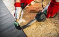 Caucasian Roofing Worker Installing EPDM Membrane Material