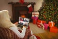 Caucasian santa claus on christmas laptop video call with diverse group of friens Royalty Free Stock Photo