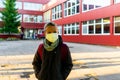 Caucasian Schoolboy wearing face mask during epidemic.Cute boy outside at school.Safety mask to coronavirus prevention Royalty Free Stock Photo