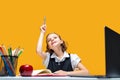 Caucasian schoolgirl raises hand up with pen sitting at laptop . Distant School Learning. Royalty Free Stock Photo