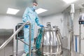 Scientist stand near big metal barrel