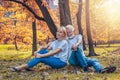 Caucasian senior couple having romance moment together in park in autumn