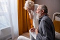 Caucasian senior couple at home, elderly wife call an ambulance to help husband with heart attack Royalty Free Stock Photo