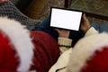 Caucasian senior couple in santa hats having christmas tablet video call, copy space on screen