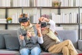 Senior couple playing video game together in living room Royalty Free Stock Photo