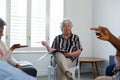 Caucasian senior female counsellor in face mask advising diverse group of senior friends Royalty Free Stock Photo