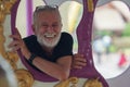 Caucasian Senior man smile on carousel at the amusement park Royalty Free Stock Photo