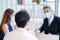 Caucasian Senior manager meeting with asian teamwork and businesspeople wearing mask preventing for Covid 19 virus. New normal and