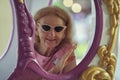 Caucasian Senior woman on merry go round at the amusement park Royalty Free Stock Photo