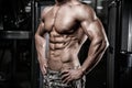 Caucasian fitness model in gym close up abs