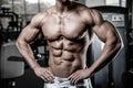 Caucasian fitness model in gym close up abs