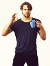 Caucasian sexy young macho holding coffee cup or mug Royalty Free Stock Photo