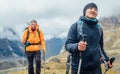 Caucasian and Sherpa men backpackers with trekking poles together hiking and enjoying Mera peak climbing acclimatization walk Royalty Free Stock Photo