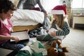 Caucasian siblings unwrapping Christmas present box