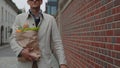 Sightless man carrying grocery bag while walking on street