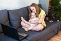 Caucasian sisters chatting online using laptop for video call. Royalty Free Stock Photo