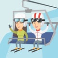 Two caucasian skiers using cableway at ski resort.