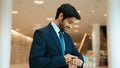 Caucasian smart business man looking at watch while waiting colleague. Exultant. Royalty Free Stock Photo