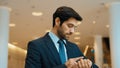 Caucasian smart business man looking at watch while waiting colleague. Exultant. Royalty Free Stock Photo