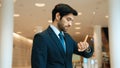 Caucasian smart business man looking at watch while waiting colleague. Exultant. Royalty Free Stock Photo