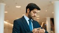 Caucasian smart business man looking at watch while waiting colleague. Exultant. Royalty Free Stock Photo