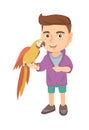 Caucasian little boy holding parrot on his hand. Royalty Free Stock Photo