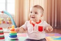 Caucasian smiling child boy with blue eyes lying on floor in kids children room Royalty Free Stock Photo