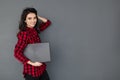 Caucasian smiling student girl holding laptop over gray background Royalty Free Stock Photo