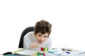 Caucasian smooth-skinned boy playing with dominoes on homework