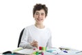 Caucasian smooth-skinned boy playing with dominoes on homework