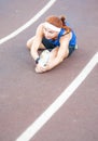 Caucasian Sporstwoman Having Stretching Exercises On Sport Venue