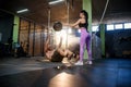 Caucasian sport man doing abdominal ball exercise with personal female trainer in the gym. Royalty Free Stock Photo