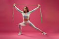 Caucasian sportswoman lunging with elastic rubber Royalty Free Stock Photo