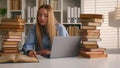 Caucasian student happy smiling girl woman studying with laptop and books homework learning online knowledge prepare for Royalty Free Stock Photo