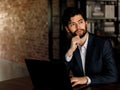 Caucasian successful professional diligent bearded and mustache male businessman in formal suit sitting at work desk typing laptop Royalty Free Stock Photo