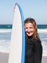 Caucasian surfer female standing on the beach shore Royalty Free Stock Photo