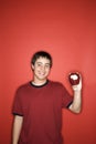 Caucasian teen boy holding apple. Royalty Free Stock Photo