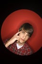 Caucasian teen boy pointing to his head.