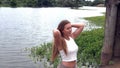 Caucasian Teen Girl At River White Top Pants Half-Length Moving Arms Sped Up