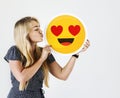 Caucasian teen holding falling in love emoji Royalty Free Stock Photo