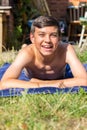 Teenage boy sunbathing in the garden Royalty Free Stock Photo