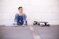 Caucasian teenage student boy sad. He is sitting on the floor in a negative attitude