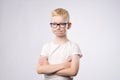 Caucasian teenager with blond hair and glasses thinking isolated on white background Royalty Free Stock Photo