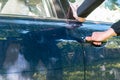 Caucasian thief hand trying to open a car door Royalty Free Stock Photo