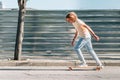 Young man skating on the city on a summer day