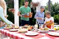 Caucasian three generation family preparing a lunch in the garden Royalty Free Stock Photo