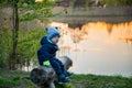 Caucasian toddle boy outdoors near lake in spring Royalty Free Stock Photo